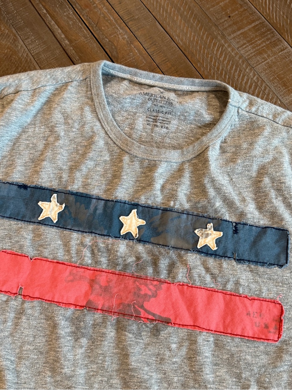 American Eagle Outfitters Gray Tee with Navy Stripe, Red Accent & Star Appliqués